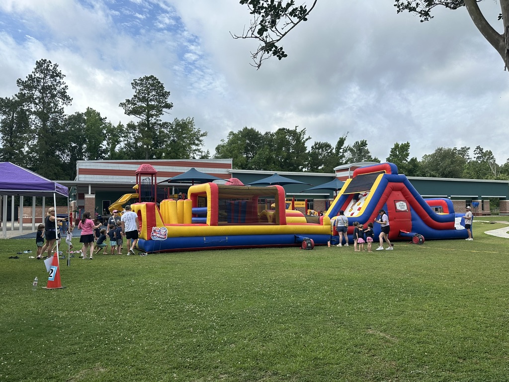 60-foot obstacle course inflated on a grass field at Madisonville Elementary